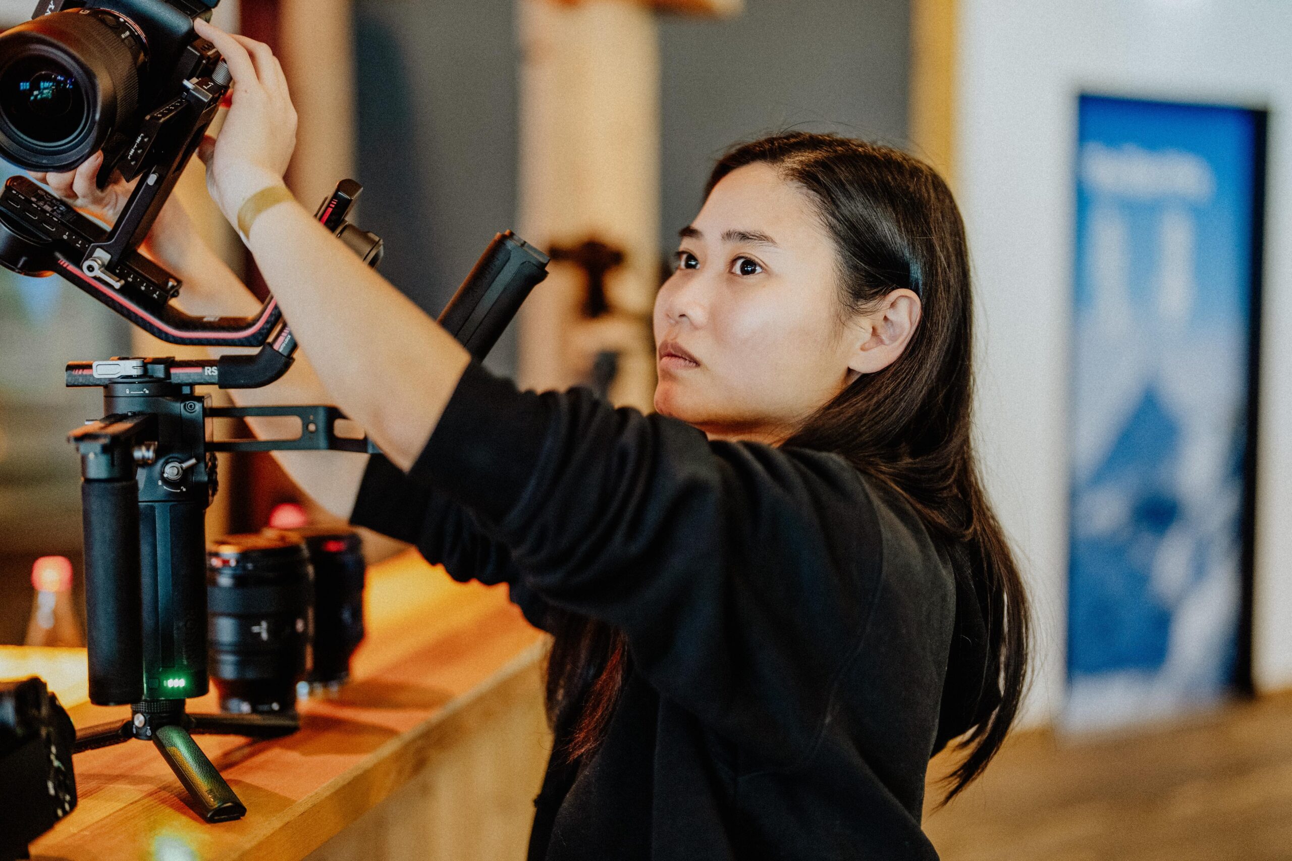 Videografin Nhung von Yourfilms aus Güstrow Mecklenburg-Vorpommern bereitet Videokamera und Gimbal vor im Alpincenter Hamburg-Wittenburg